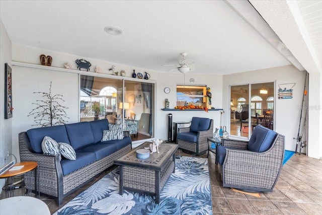 living room with beamed ceiling and ceiling fan