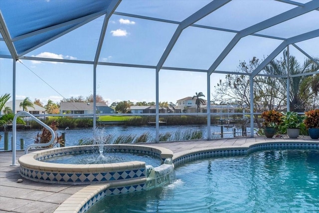 view of swimming pool with glass enclosure, pool water feature, a water view, and a patio