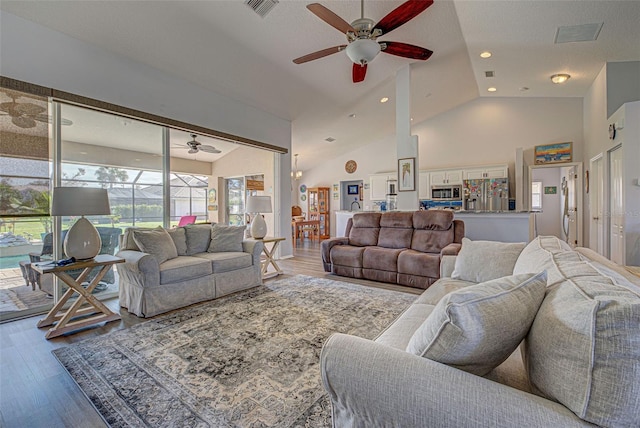 living room with ceiling fan, hardwood / wood-style flooring, and high vaulted ceiling