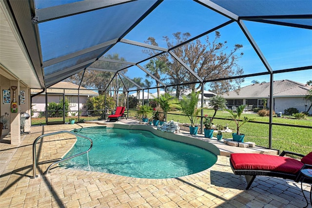 view of pool with a patio area, a yard, and glass enclosure