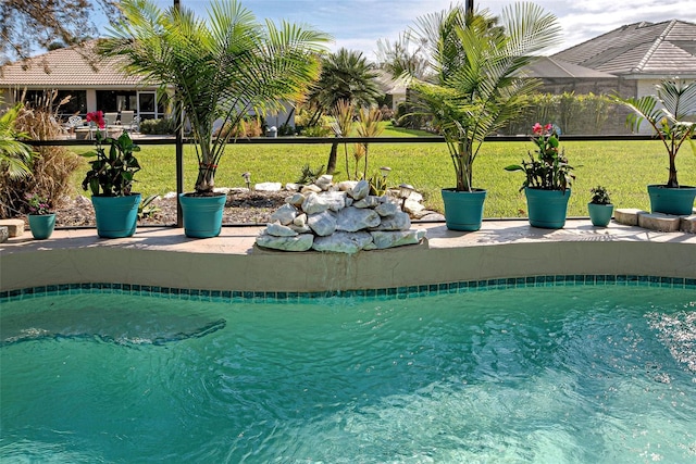 view of pool featuring a yard and a patio area