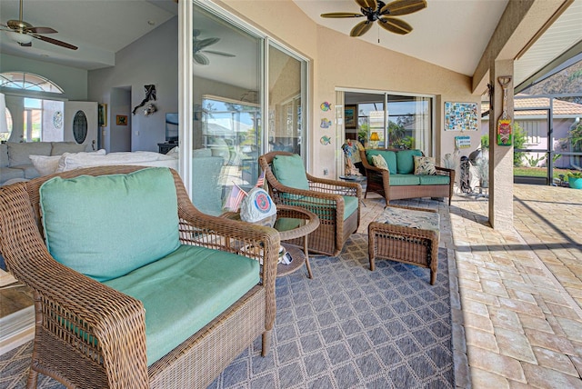 sunroom featuring ceiling fan and vaulted ceiling