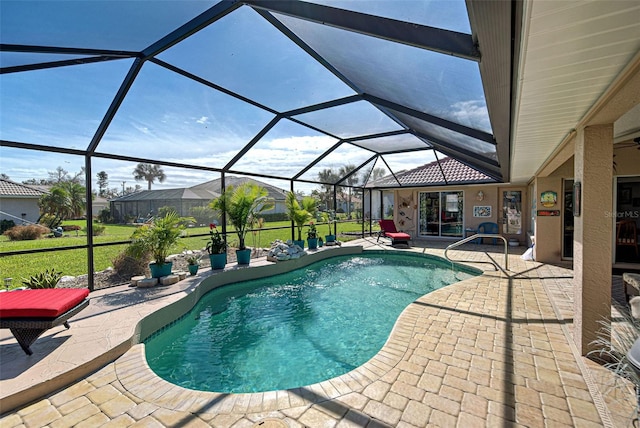 view of swimming pool with a yard, a patio area, and a lanai