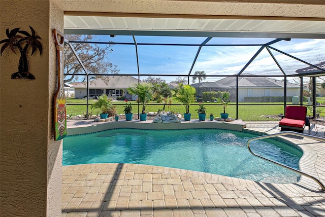 view of pool with a patio area, a lawn, and a lanai