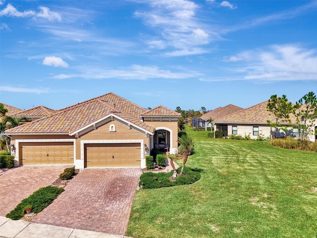 view of front of home with a front yard and a garage