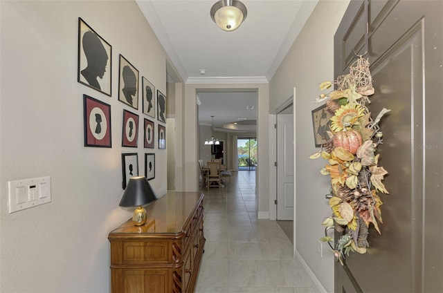 hall with crown molding, a chandelier, and light tile patterned flooring