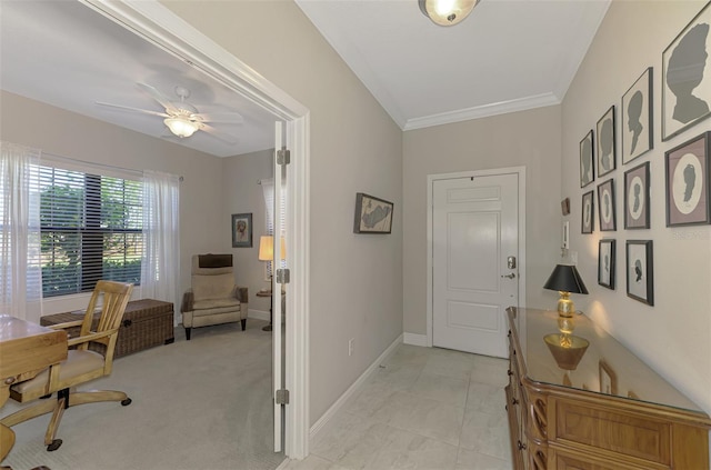 interior space with crown molding, light colored carpet, and ceiling fan