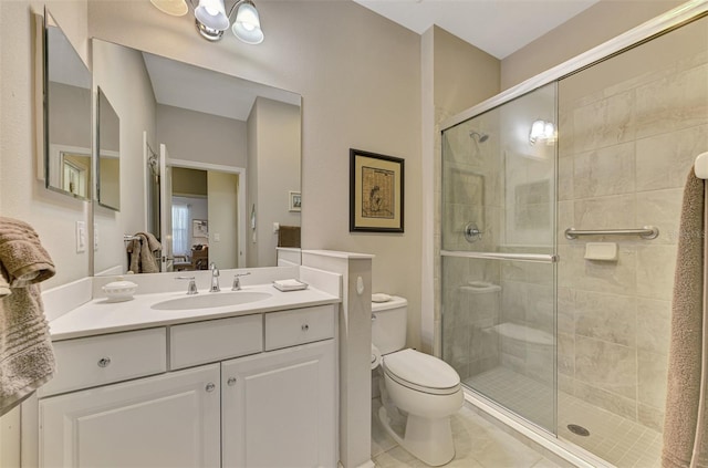 bathroom with vanity, a shower with shower door, toilet, and tile patterned flooring