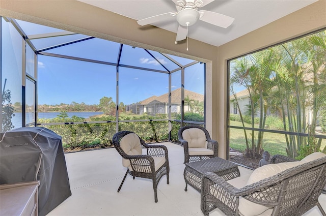 sunroom with a water view and ceiling fan