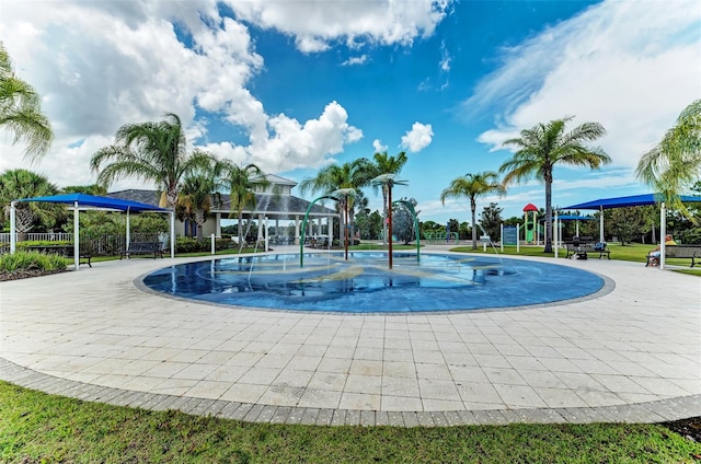 view of swimming pool featuring a playground