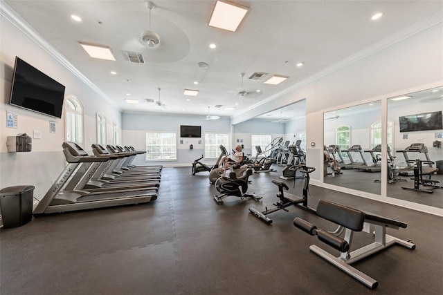 gym featuring ceiling fan and crown molding