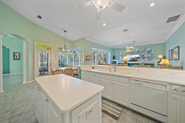 kitchen featuring dishwasher, ornate columns, a center island, decorative light fixtures, and white cabinets