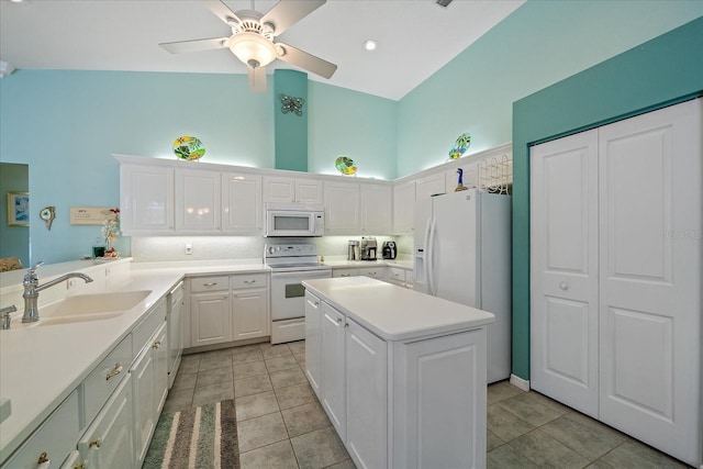 kitchen featuring white cabinets, a kitchen island, light tile patterned flooring, sink, and white appliances