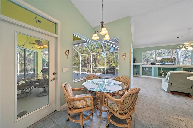 dining area featuring vaulted ceiling and light tile patterned floors