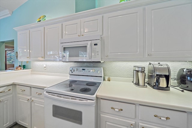 kitchen with white appliances, backsplash, and white cabinetry