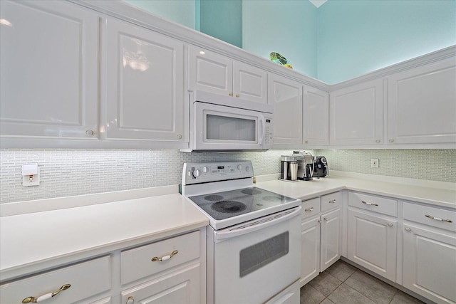 kitchen featuring backsplash, white cabinetry, white appliances, and light tile patterned floors