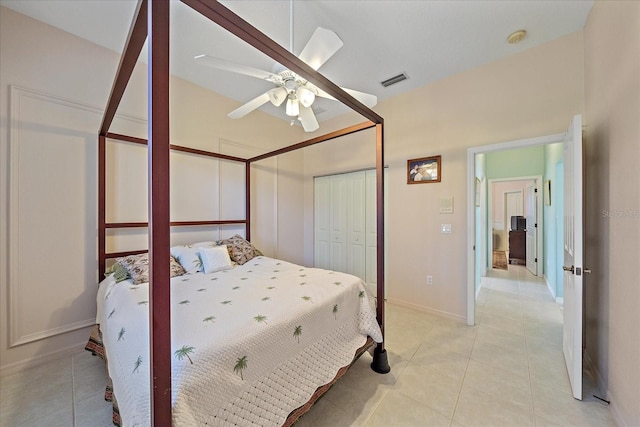 bedroom featuring a closet, light tile patterned floors, and ceiling fan