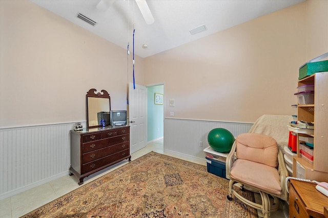 living area featuring ceiling fan, lofted ceiling, and light tile patterned floors