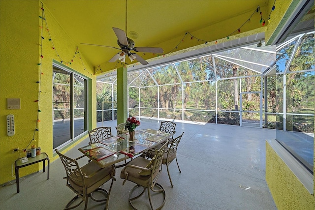 unfurnished sunroom with ceiling fan and vaulted ceiling