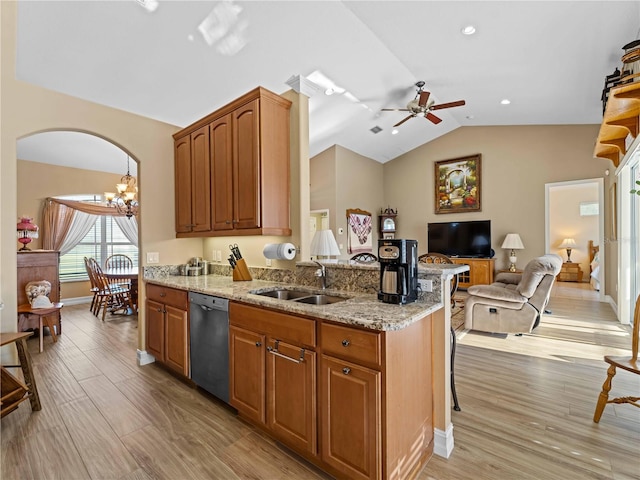 kitchen featuring light stone countertops, stainless steel dishwasher, vaulted ceiling, light hardwood / wood-style floors, and sink