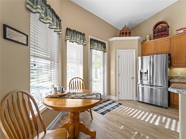 dining space with light hardwood / wood-style flooring