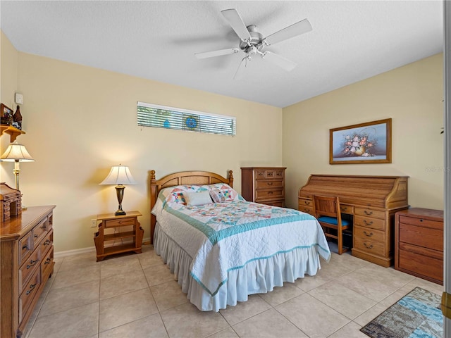 bedroom featuring ceiling fan, a textured ceiling, and light tile patterned floors