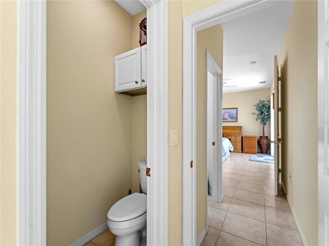 bathroom with toilet and tile patterned flooring