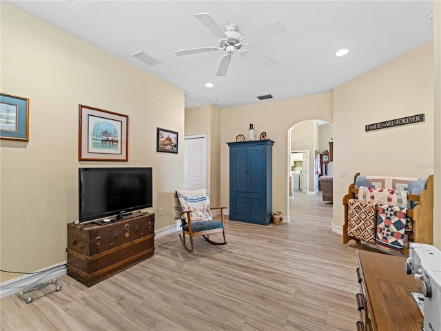 living area with ceiling fan and light wood-type flooring