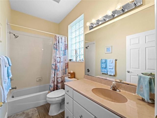 full bathroom with vanity, hardwood / wood-style floors, shower / bath combination with curtain, and toilet