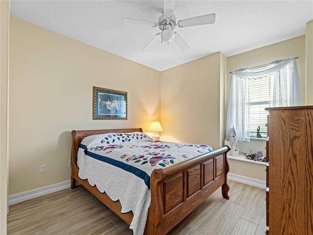 bedroom featuring light wood-type flooring and ceiling fan