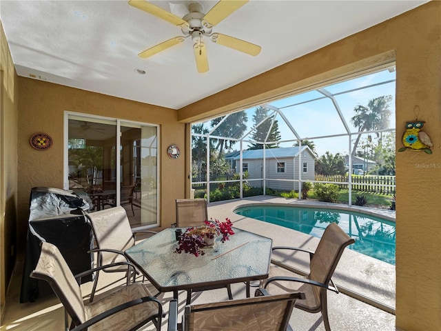 view of pool featuring a patio area, ceiling fan, and glass enclosure