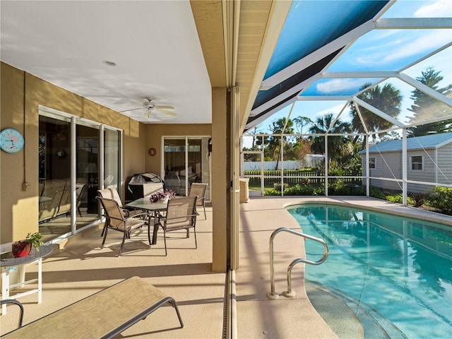 view of pool with a patio, a lanai, and ceiling fan