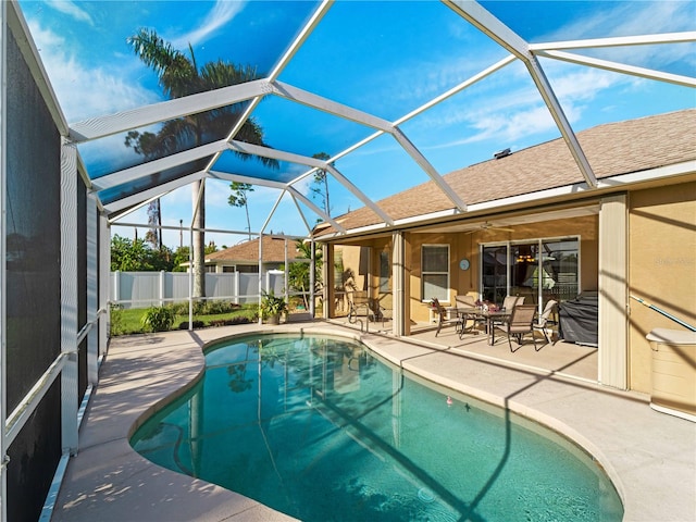 view of pool featuring a patio area and glass enclosure