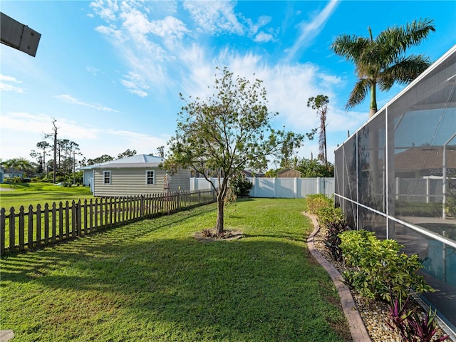 view of yard featuring glass enclosure