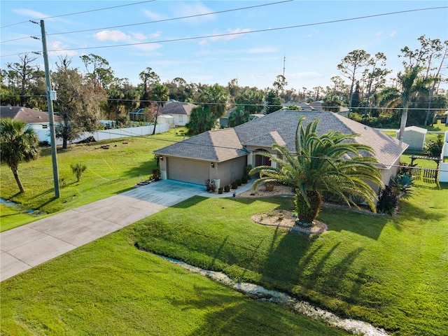 view of front of house featuring a front yard and a garage