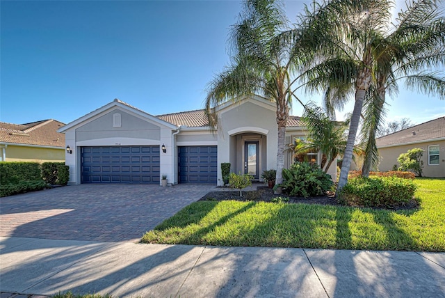 view of front of property with a front yard and a garage