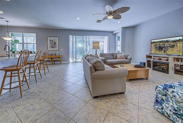 tiled living room featuring sink and ceiling fan