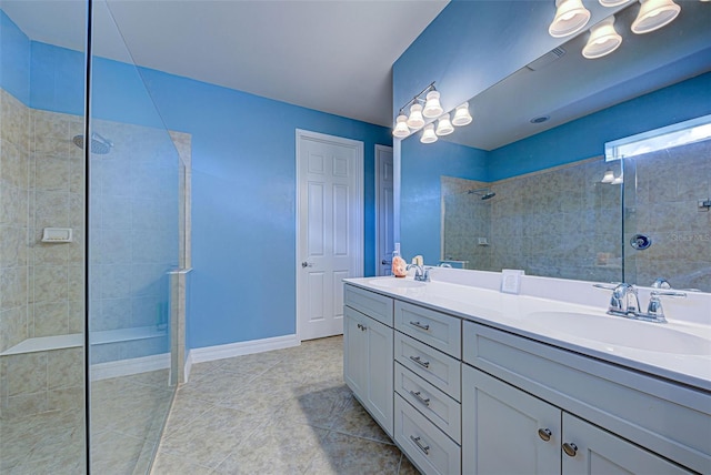 bathroom featuring vanity, tile patterned floors, and tiled shower