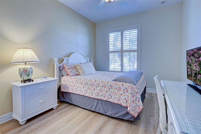 bedroom with light hardwood / wood-style floors and ceiling fan