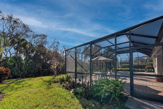 view of yard with a patio and a lanai