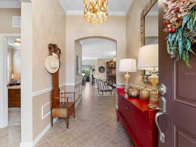 corridor with tile patterned flooring and crown molding