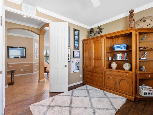 bedroom with ornamental molding and dark hardwood / wood-style flooring