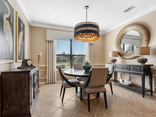 dining space with ornamental molding, light tile patterned floors, and a notable chandelier