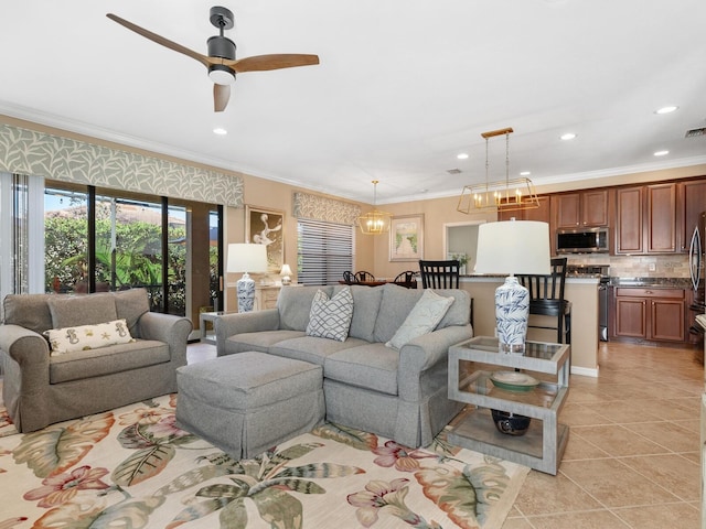 living room with crown molding, light tile patterned floors, and ceiling fan