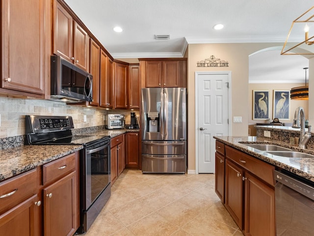 kitchen featuring sink, crown molding, light tile patterned floors, appliances with stainless steel finishes, and stone counters