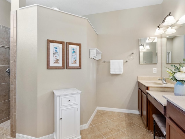 bathroom with tiled shower, vanity, and tile patterned floors