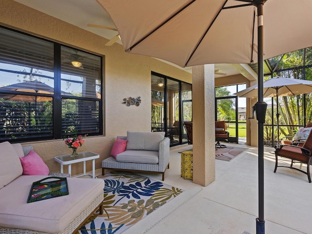 view of patio with an outdoor living space, a lanai, and ceiling fan