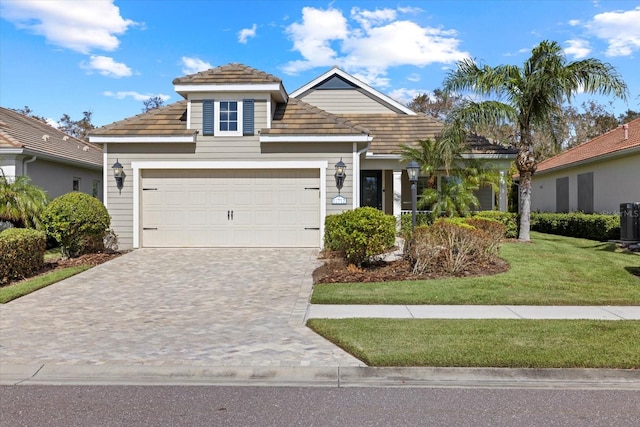 view of front facade with a front lawn and a garage