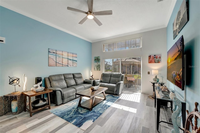 living room with crown molding, ceiling fan, light hardwood / wood-style floors, and a high ceiling