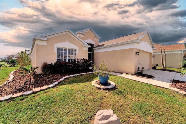 ranch-style house featuring a lawn and a garage